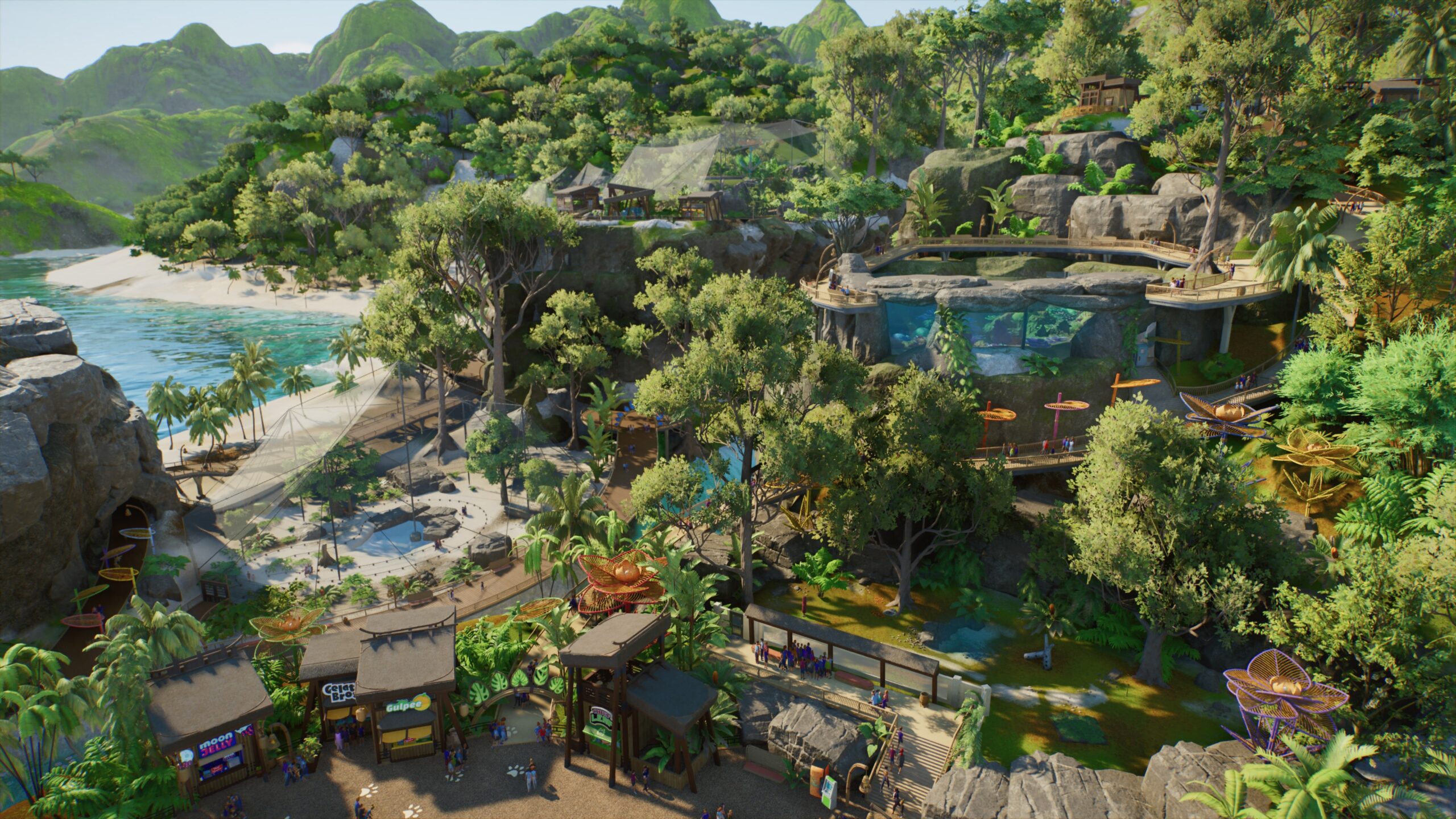 Aerial view of a lush coastal zoo with paths, visitor shops and habitats in Planet Zoo 2.